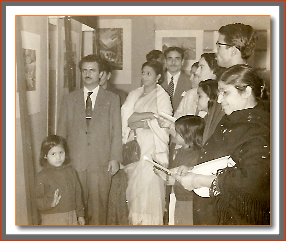 Family viewing paintings at the 1957 exhibition